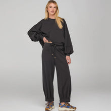 Load image into Gallery viewer, Person wearing a black outfit with a plain background