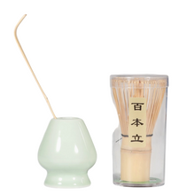 Load image into Gallery viewer, Matcha whisk holder with a green base and a glass container with wooden sticks on a white background