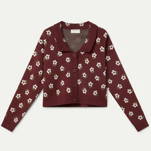 Load image into Gallery viewer, A long-sleeve cropped cardigan in deep burgundy with a repeating white and beige floral pattern, laid flat against a light gray background.
