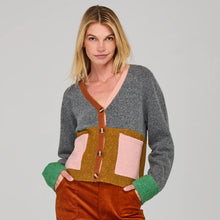 Load image into Gallery viewer, Woman wearing a colorful cardigan with a neutral background
